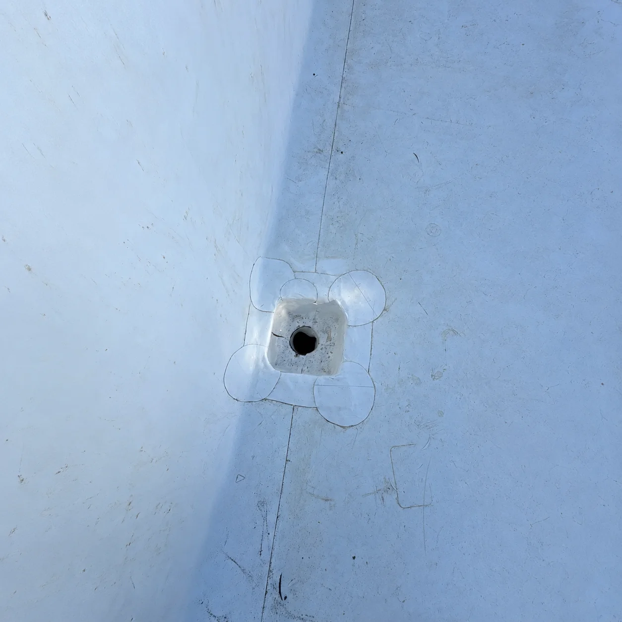 A roof drain sealed tight around its collar.