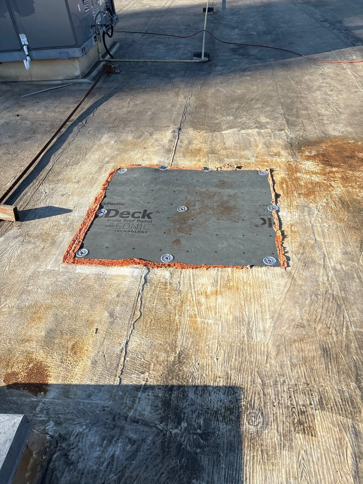 A rebuilt section of decking set into a flat roof.