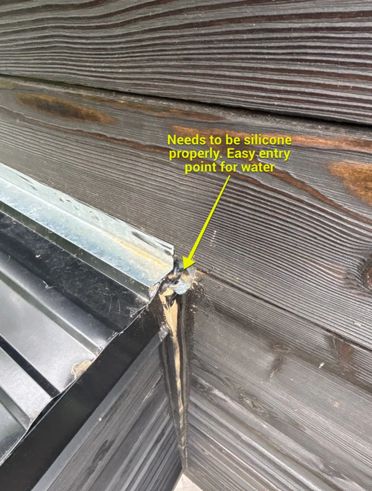 An annotated inspection photo showing a vulnerable exterior wall and roof edge detail that needs sealing.