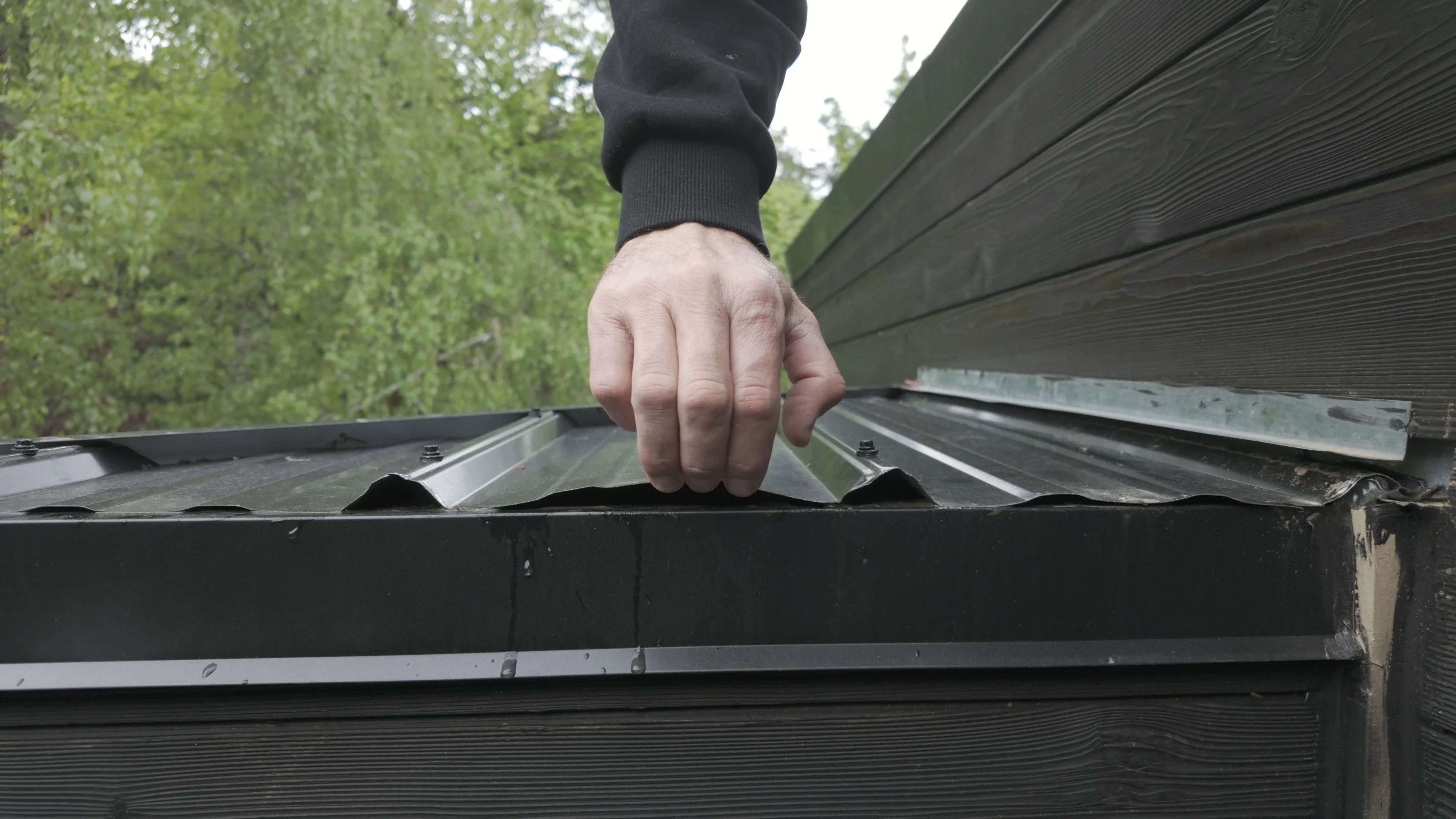 Flat-roof specialist inspecting a commercial roof detail